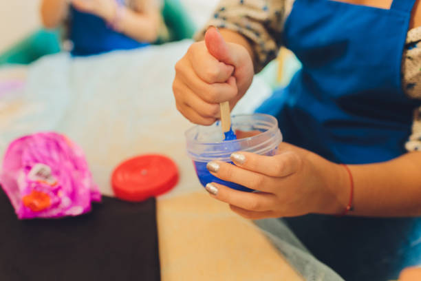 istock Ingredient for make home made Toy Called Slime, Teenager having fun and being creative homemade slime. Selective focus on Slime. 1284472957