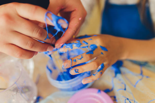 istock Ingredient for make home made Toy Called Slime, Teenager having fun and being creative homemade slime. Selective focus on Slime. 1284472985