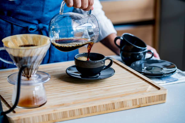 istock Man making coffee in the kitchen. Delicious coffee image. 1284473494