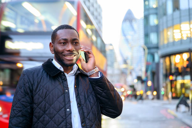 istock Smiling African businessman using smart phone outdoors 1284474008