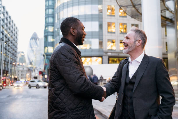 istock Mature businessmen shaking hands in greeting after work 1284474022