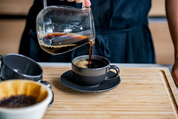 istock Man making coffee in the kitchen. Delicious coffee image. 1284474123