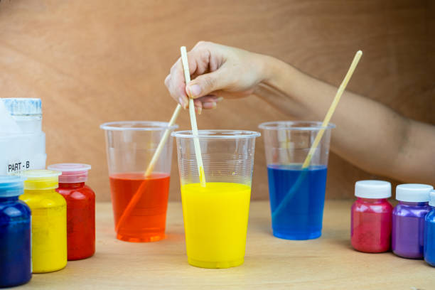 istock Mixing color epoxy resin in a plastic cup for casting stabilizing wood 1284475694