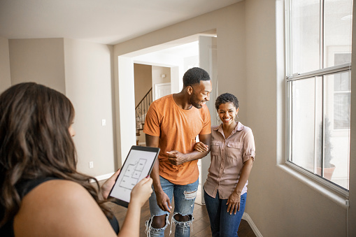 An African American couple Looking for a new Home with a real estate agent.