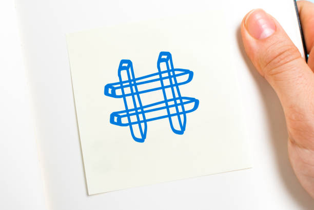 istock Hashtag symbol on adhesive note and paper notebook and white background. 1284481357