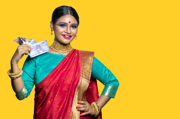istock Beautiful Young woman holding Indian rupee notes 1284491759