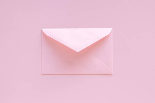 istock Pink envelope with greeting card on pastel pink background. Letter with congratulations, letter to Santa Claus. Christmas or New Year 2021 minimal concept. View from abovelay 1284492555