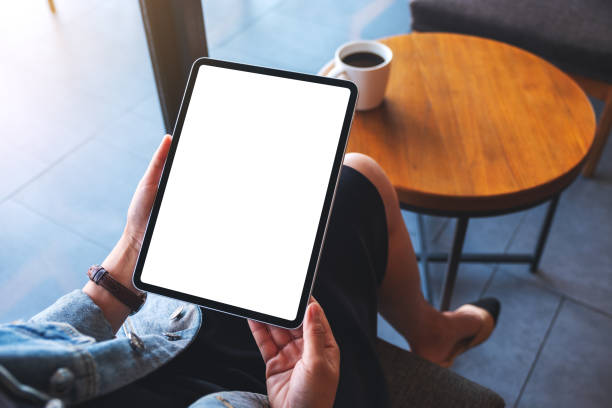 istock a woman holding digital tablet with blank white desktop screen 1284499170
