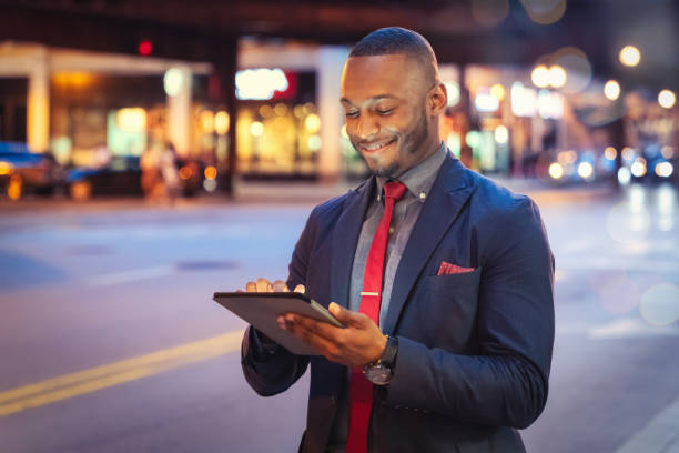 istock Businessman using Digital Tablet Computer in Chicago Streets at Night 1284500059