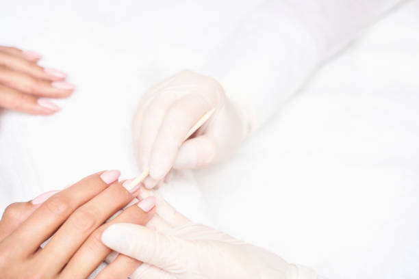 istock Classic pink wedding nail manicure on white backdrop. Spa treatment concept 1284502217