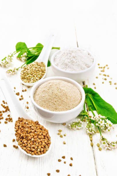 istock Flour buckwheat brown and green in bowls on light board 1284502264