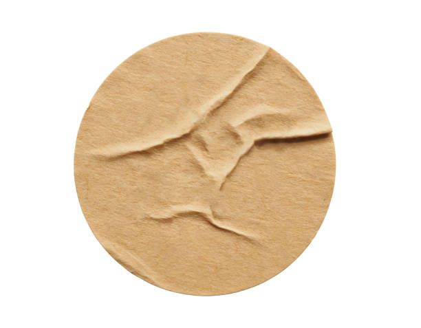 istock Brown round paper sticker label isolated on white background 1284502850