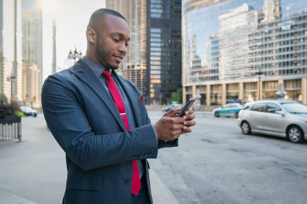 istock African American Businessman using Mobile Phone in Chicago Streets 1284503123