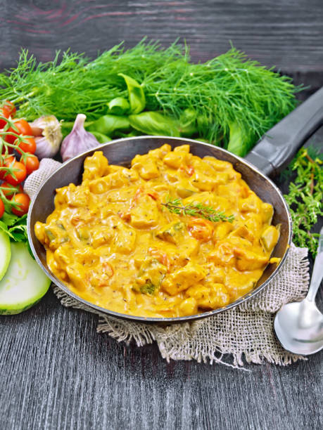istock Goulash with tomato and zucchini in pan on black board 1284504539