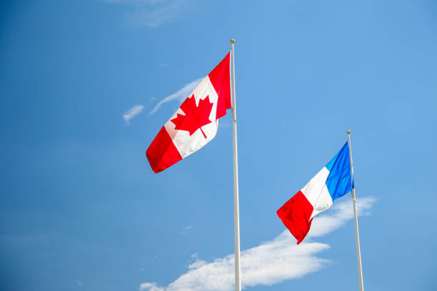 istock Canada and France flags flying against a blue sky 1284506887