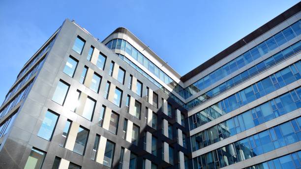 istock Abstract texture and blue glass facade in modern office building. 1284507612