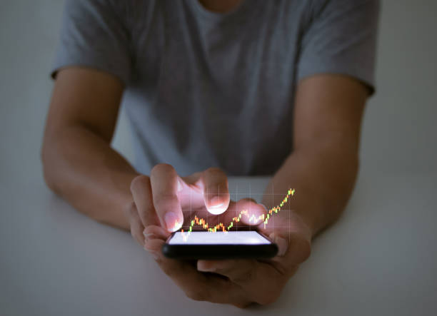 istock A man use checking a business graph with a hand touch screen smartphone technology