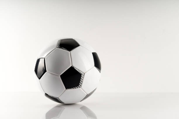 istock Classic soccer ball, typical black and white pattern, isolated on white background. 1284510441