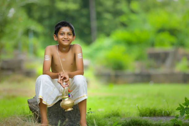 A indian priest child with holy water pot