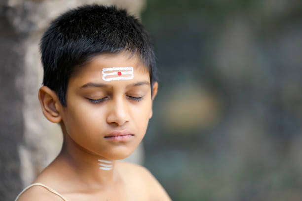 the indian priest child doing meditation