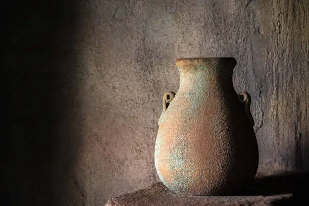 Drinking earthenware jug on stone shelf indoors