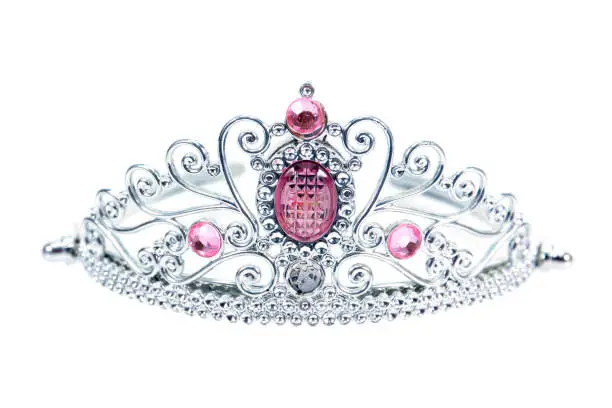 Tiara decoration with pink diamonds isolated on white background. Plastic crown beauty decorative with gems and diamonds isolated