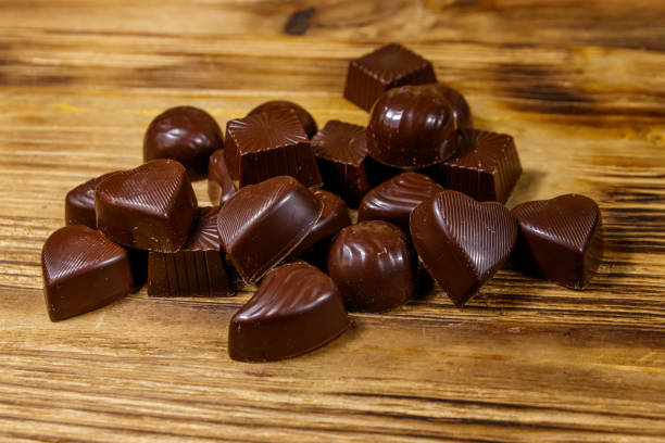 istock Tasty chocolate candies on wooden table 1284521403