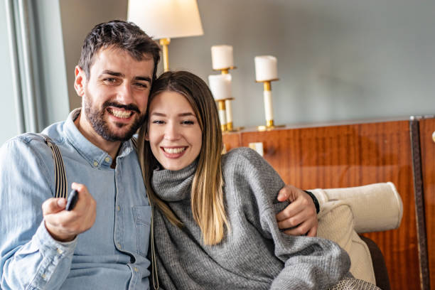 istock Young couple watching tv at home 1284527870
