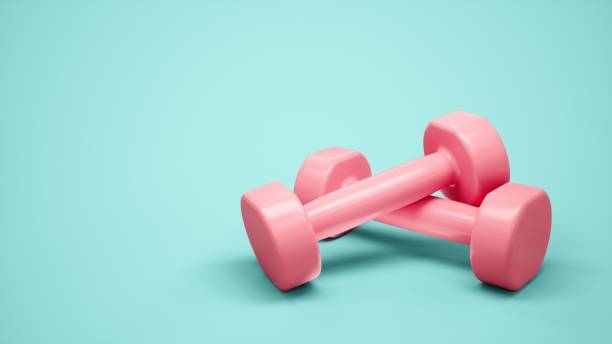 istock 3D rendering Pink Dumbbells for sports isolated on blue background 1284528102
