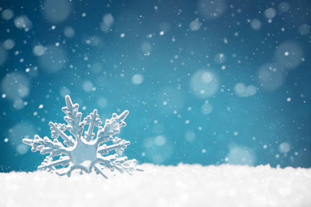 istock Transparent shape of a snowflake in a snowdrift on a blue background 1284529663