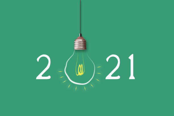 2021 Happy New Year. Light bulb on a green background.