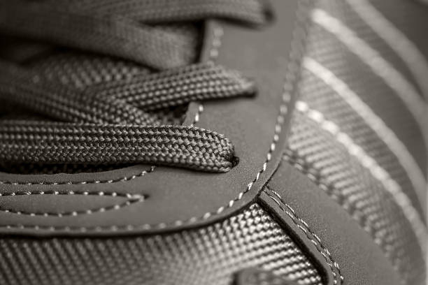 texture of sports shoes knotted laces on gumshoes fashionable Stylish sneaker close-up stock photo