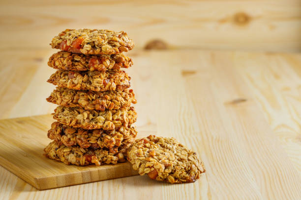 istock Sweet oatmeal cookies on a wooden table. 1284533128
