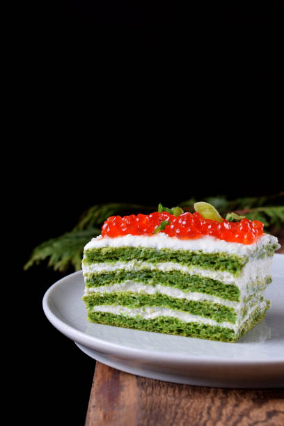istock Appetizer cake with spinach, cream cheese and red caviar 1284535526