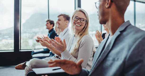istock Audience applauding speaker after conference presentation 1284538766