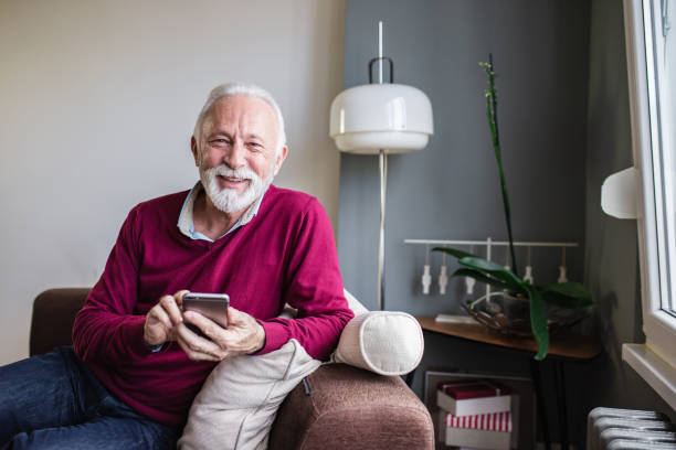 istock A portrait of a senior man using mobile phone at home 1284539551