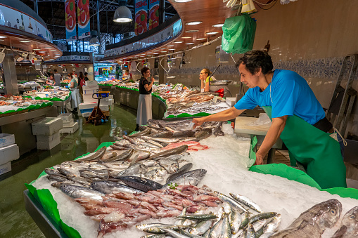 Horizontal shot of the fishes, fish vendors and general atmosphere of La Pescheria, the popular fish market, Catania, Sicily