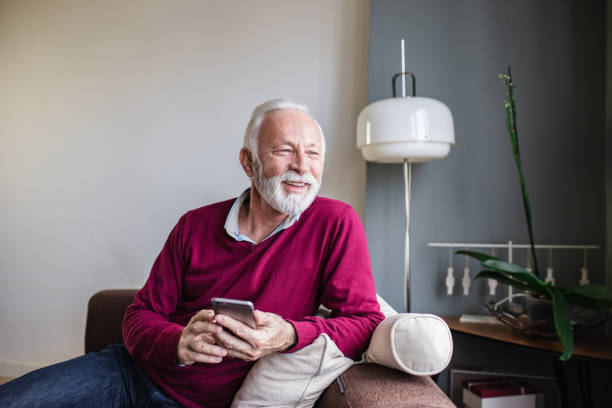 istock A portrait of a senior man using mobile phone at home 1284540144