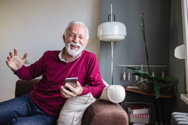 istock A portrait of a senior man using mobile phone at home 1284540181