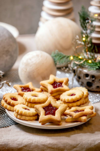 istock Christmas Linz shortbread biscuits cookies with wooden decorations on xmas table 1284543507