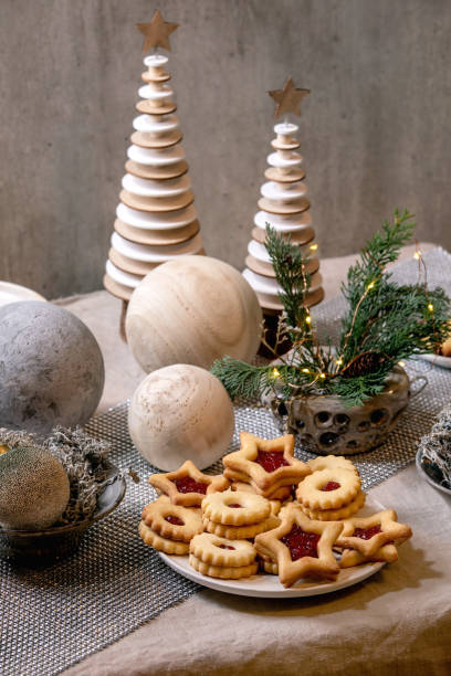 istock Christmas Linz shortbread biscuits cookies with wooden decorations on xmas table 1284543511