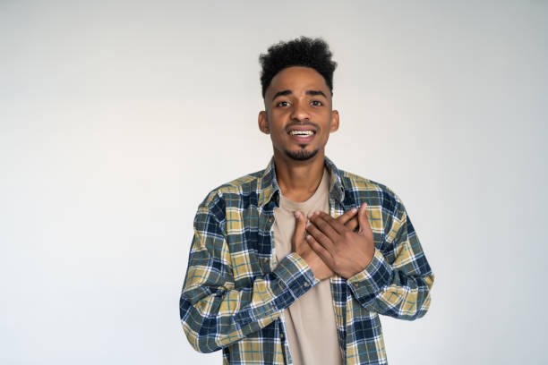 istock African man holding hands on the heart on white background. 1284544913
