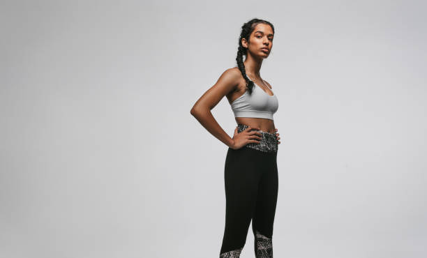istock Fit woman standing against white background 1284544949