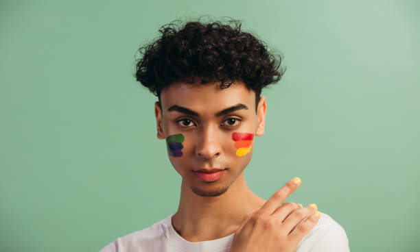 istock Man with LGBT flag painted on his cheeks 1284546014