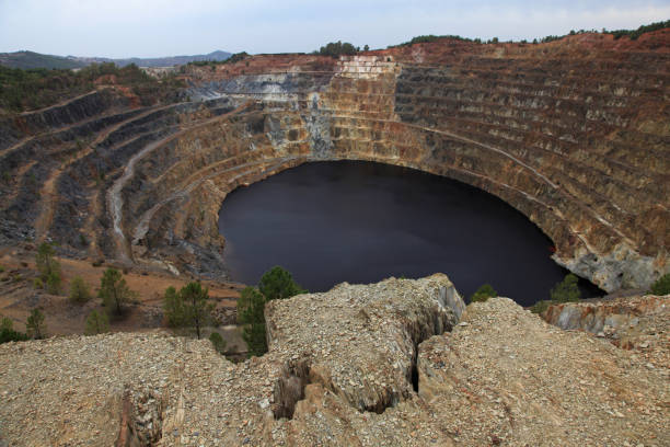 istock Inactive quarry with a red lake at the bottom. 1284546164
