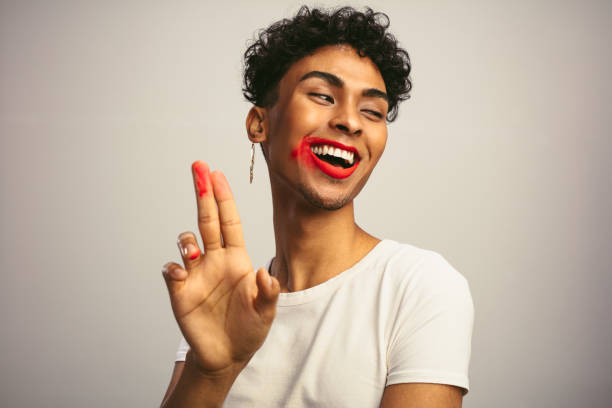 istock Gay man with smeared lipstick showing his fingers 1284546396