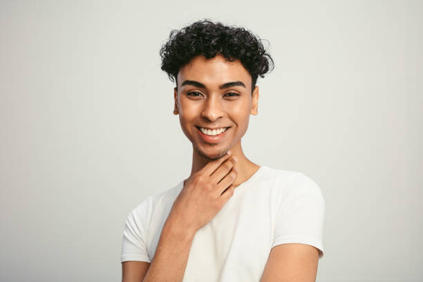 knappe vrolijke mens op witte achtergrond - transgender stockfoto's en -beelden