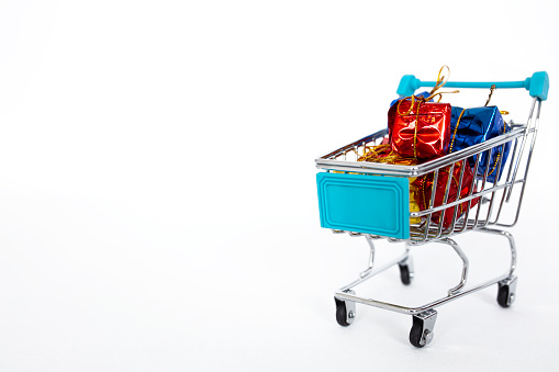 Christmas and New Year shopping. Shopping cart full of gifts