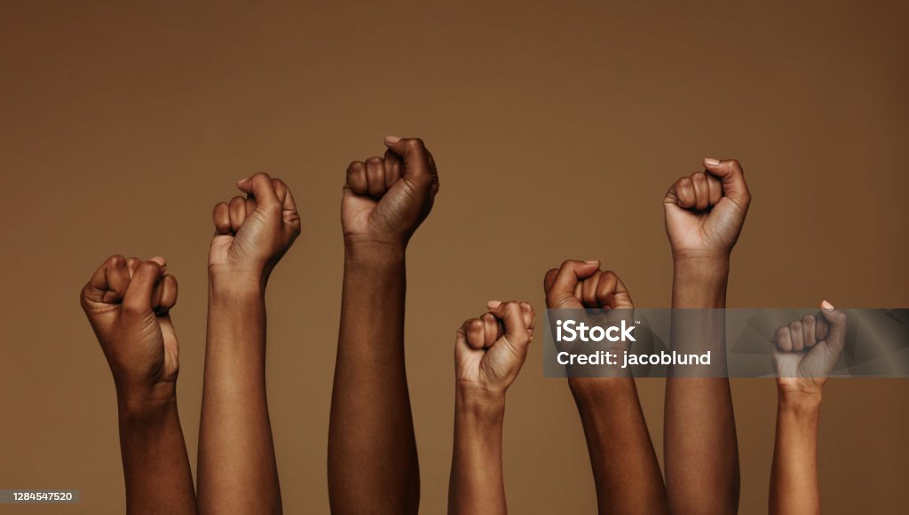 Fists raised for equality Cropped shot of hands raised with closed fists. Multiple hands raised up with closed fist symbolizing the protests movement. African Ethnicity Stock Photo