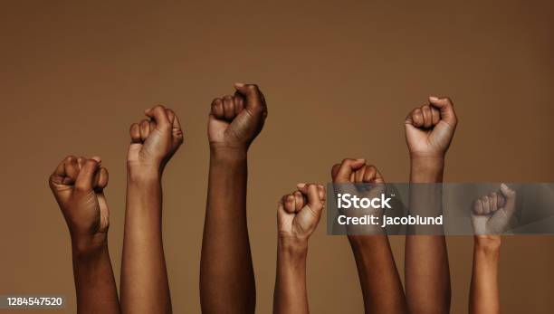 Fists Raised For Equality Stock Photo - Download Image Now - African Ethnicity, African-American Ethnicity, Black Color
